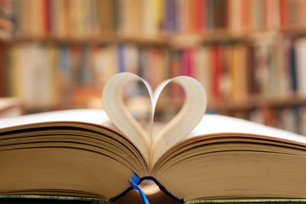 A book with its pages folded into a heart shape, symbolising publc support for universities