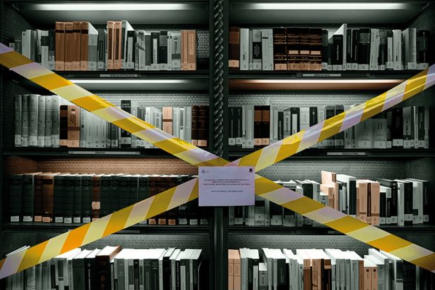Books on taped-off library shelf
