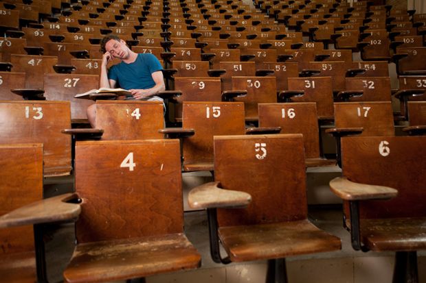 Bored student asleep in empty lecture hall