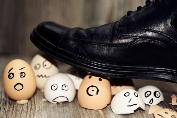 Broken eggs under man’s shoe