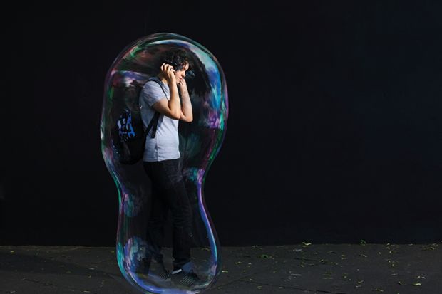 Young man inside giant bubble