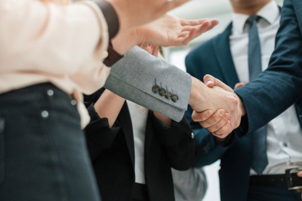 Business partners shaking hands in the office