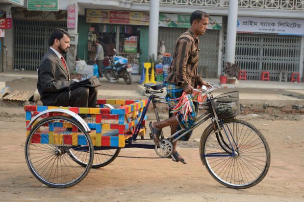Businessman being transported on rickshaw