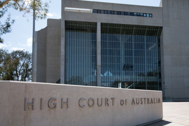 Canberra, Australia - March 10, 2020 Ground-level external view of the High Court of Australia building, characterized by a large inscribed granite sign on the site