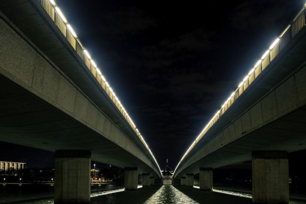 Canberra, Australia - Sep 8, 2018 Night view of the Commonwealth Avenue bridges from underneath. Parliament House in the distance.