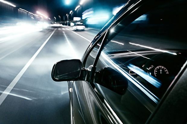 Car driving quickly into European motorway fast lane