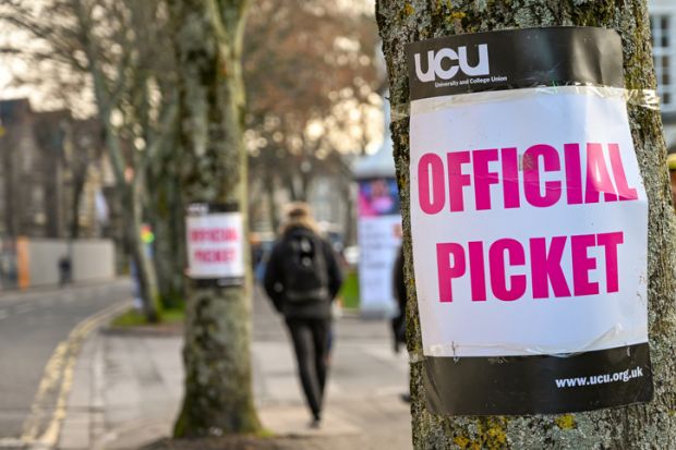 Cardiff, Wales - November 2019 Sign attached to a tree near an official picket line outside Cardiff University. It marks industrial action by members of the Universities and College Union.