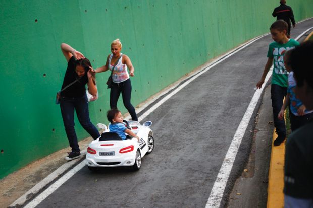 Child drives miniature car into people