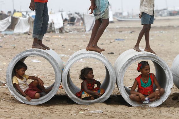 Children inside water pipes, Marina Beach, Chennai, India