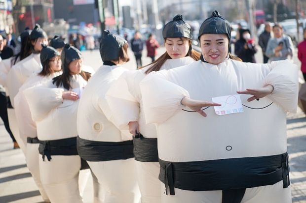 Women dressed in inflatable sumo-wrestler costumes to illustrate Universities ‘partly to blame’ for Chinese graduates’ job woes