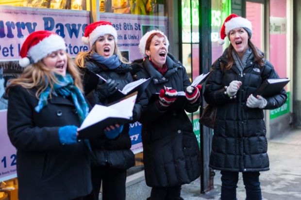 Christmas carollers in Santa hats