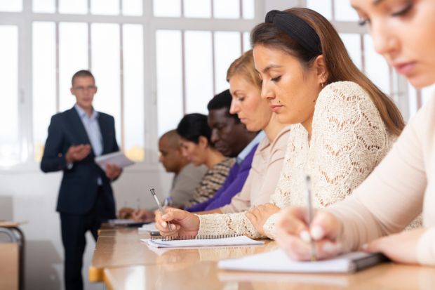 A lecturer looks at a female student in class, illustrating flirtation