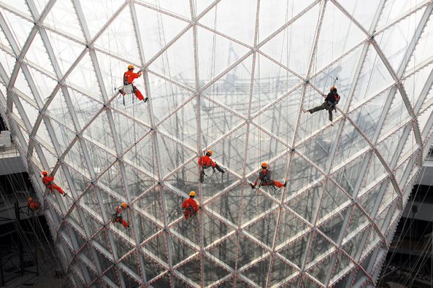 Workers clean the exterior of the Sun Valley pavilion in Shanghai, China