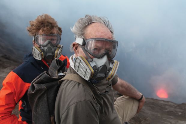Clive Oppenheimer and Wwerner Herzog standing beside volcano