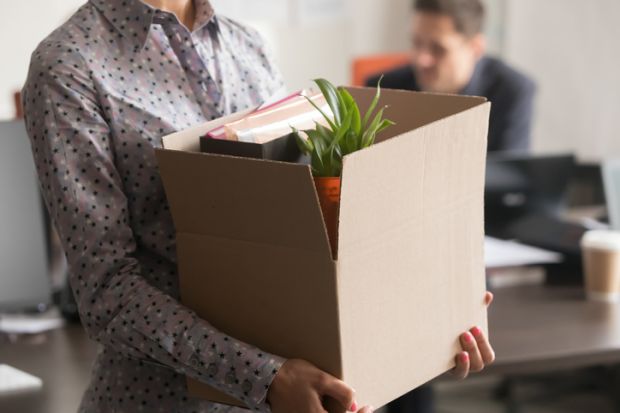 Close up view of female employee holding box, quitting job