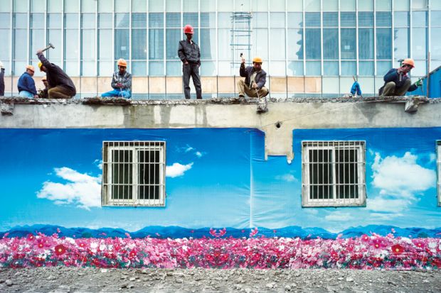 Construction crew dismantle a building, Shanghai, China