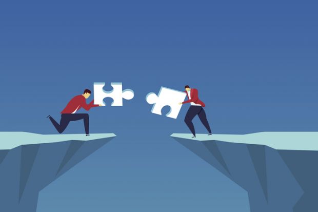 People fit jigsaw pieces together across a chasm, symbolising cooperation