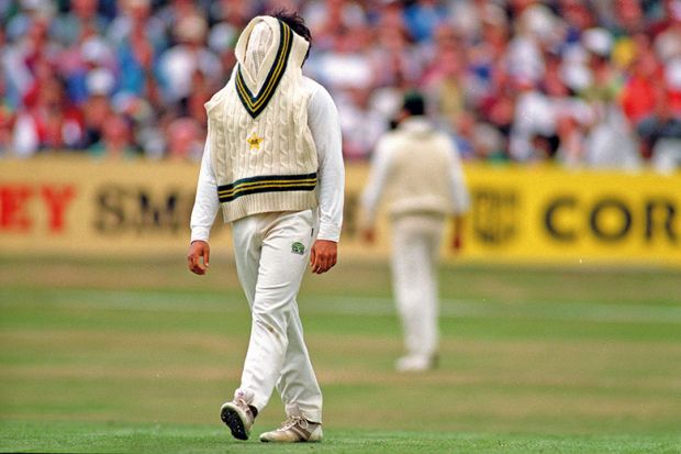 Cricketer with jumper over face