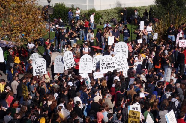 Crowd of protesters hold signs and rally tuition increases in front of Sproul Hall on UC Berkeley November 18 2009
