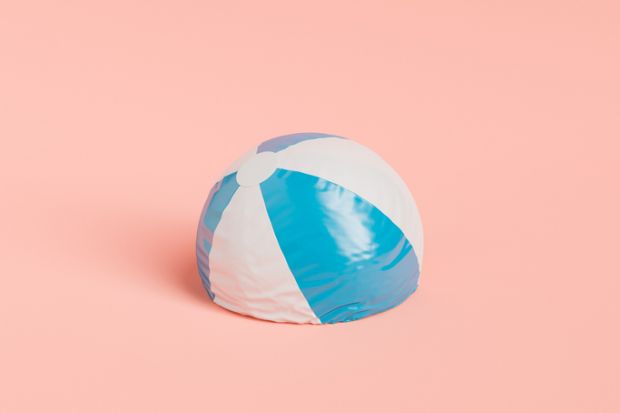 Deflated beach ball with stripes