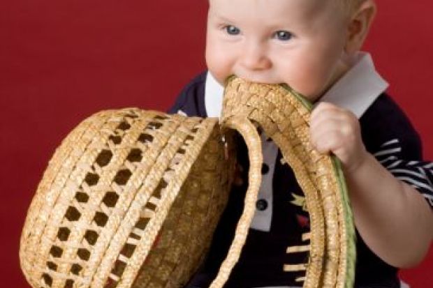 Toddler eating his hat