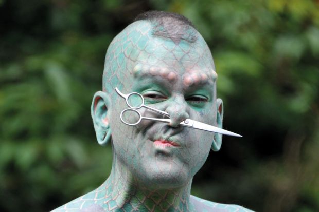 Erik Sprague (The Lizardman) with scissors through nose