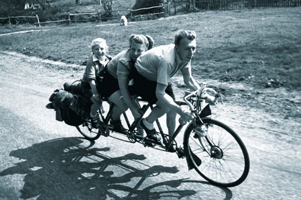 Family riding three-seat bicycle