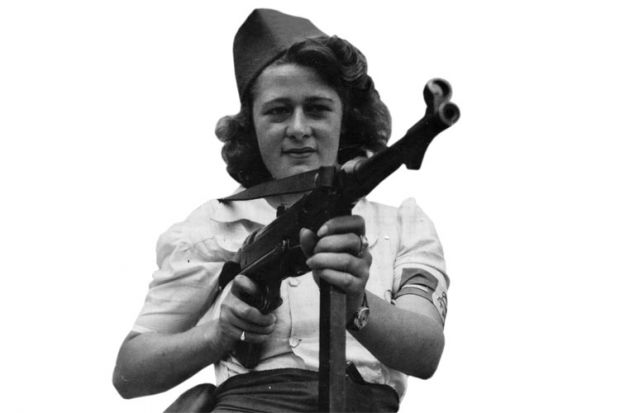 Female French Resistance fighter holding machine gun