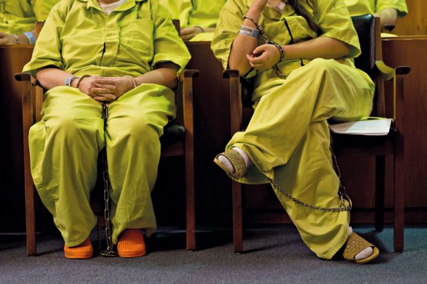 Female prisoners sitting in court room