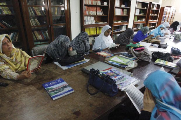 Female students reading in Peshawar University library
