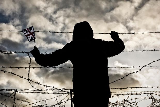 Silhouetted figure holds Union Jack