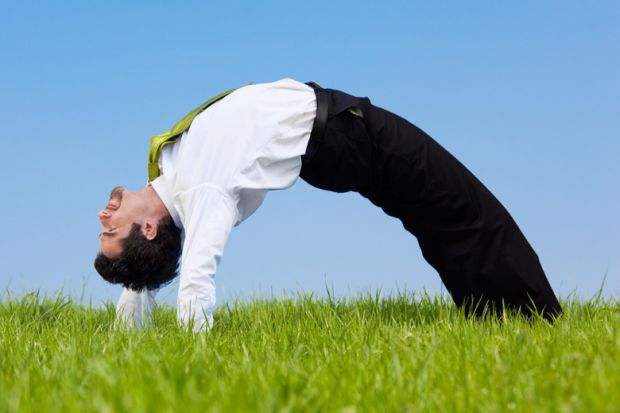 Flexible businessman bending over backwards