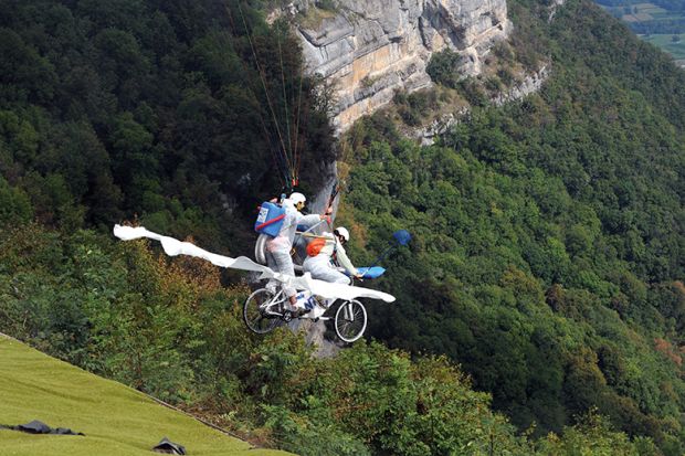 Paragliders compete on their “tandem bicycle” in Saint-Hilaire du Touvet, France, 2012, illustrating entrepreneurship