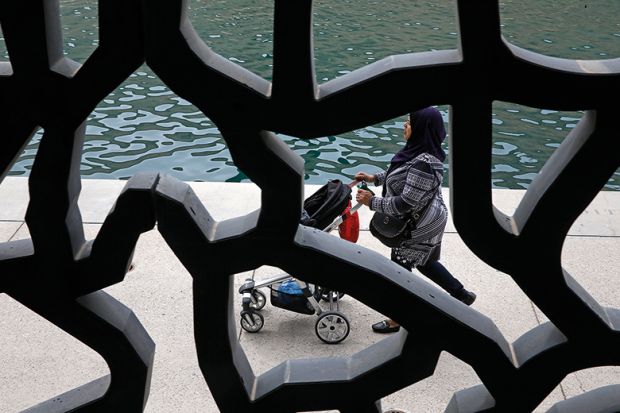 View from the MUCEM museum, Marseille, France, showing a woman pushing a pushchair. View is obscured - to illustrate how universities offer little evidence of their gender equality efforts
