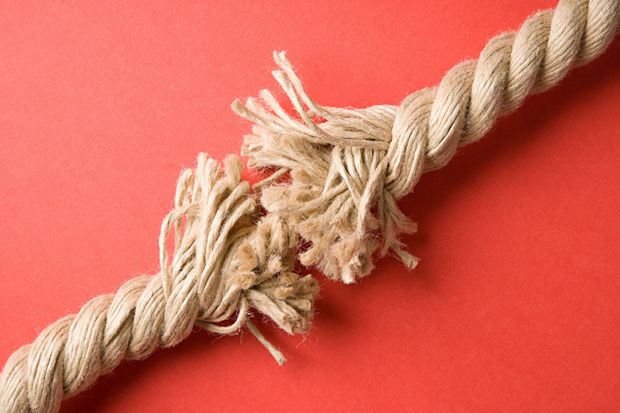 Frayed rope on red background