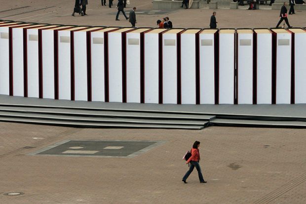 Visitors walk past giant books at the Frankfurt Book Fair. Germany