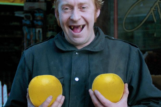 Man holding pair of grapefruit