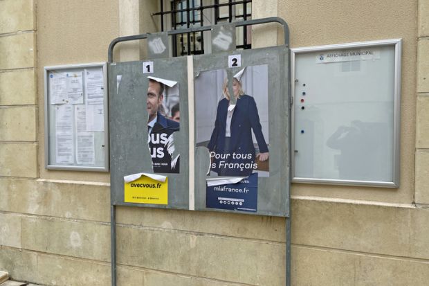 Gréoux-les-Bains, France - April 24, 2022 Torn France presidential election posters showing politicians Emmanuel Macron and Marine Le Pen.
