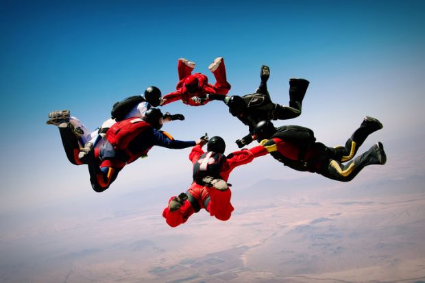 Group of skydivers making a circle