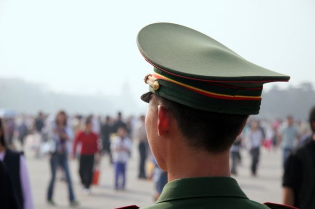Guardian Officer at Tiananmen Place, China illustrating surveillance of international students