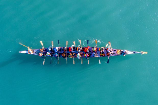 Haifa, Israel - December 11, 2020 Dragon Boat team rowing to the pace of an onboard Drummer