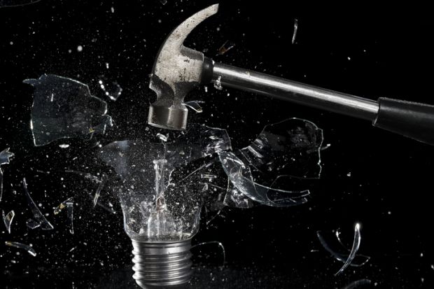 A hammer smashes a lightbulb