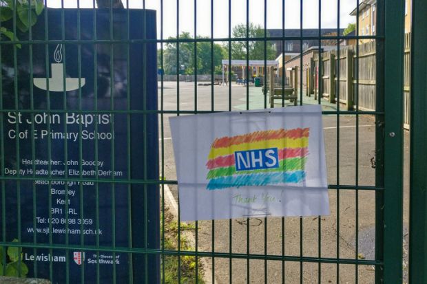 Hand drawn rainbow with thank you note to NHS displayed on fence