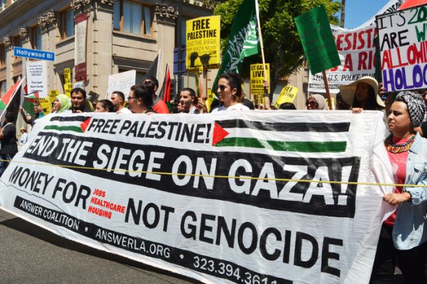 Hollywood, CA,, USA - August 16, 2014 Protestors with signs and flags march along Hollywood Boulevard behind a banner which reads, End The Siege On Gaza on August 16, 2014 in Hollywood, California.