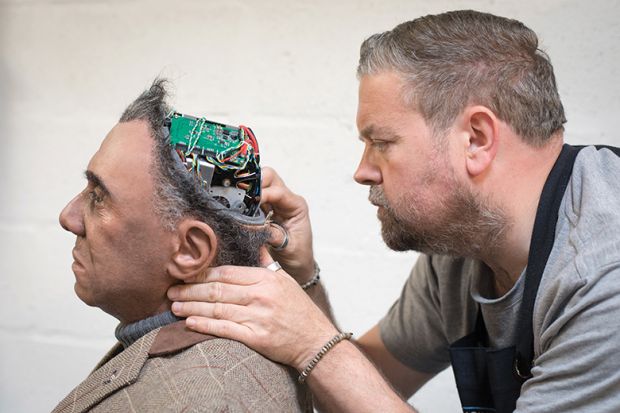 Engineered Arts prosthetic expert Mike Humphrey checks on Fred, a Mesmer robot built at the company’s headquarters in Penryn, Cornwall