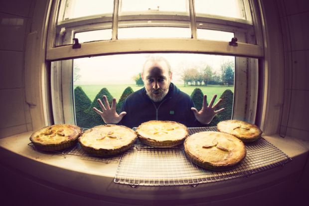 Hungry man looking longingly at row of pies