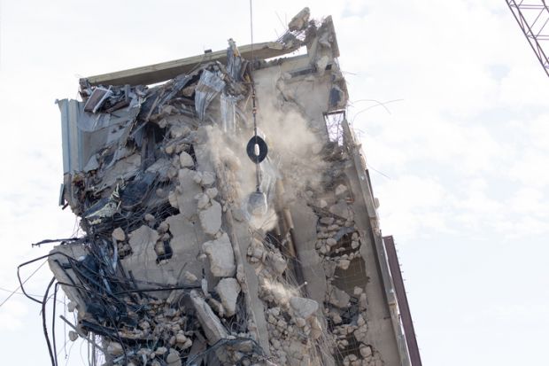 Images of the Leaning Tower of Dallas, a building undergoing demolition, but has yet to fall. Dallas citizens have gathered daily to watch a wrecking ball attempt to knock the building down.