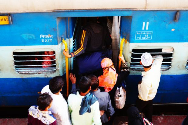 People crowd onto an Indian train, symbolising university admissions