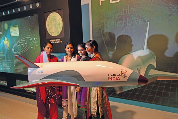 indian women next to indian space shuttle