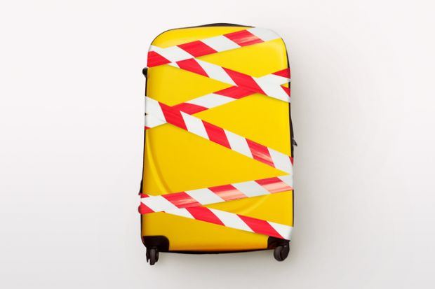 A yellow suitcase bound up with tape